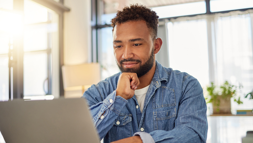 man at laptop wearing Ejis undershirt